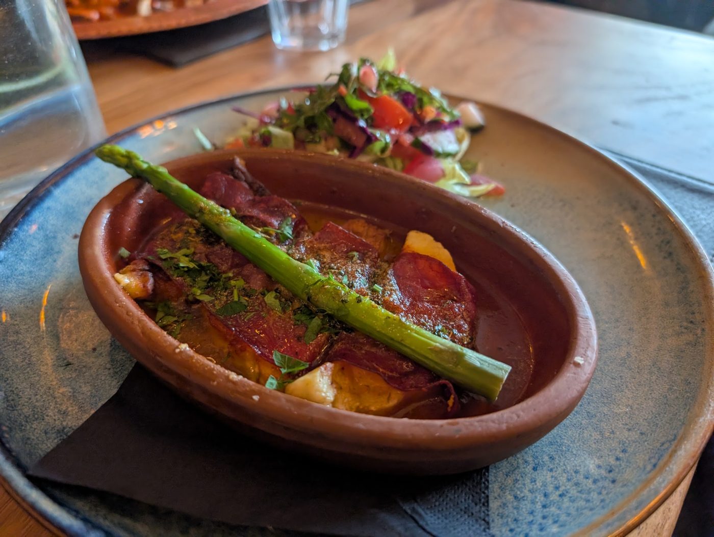 A dish served in a terracotta bowl