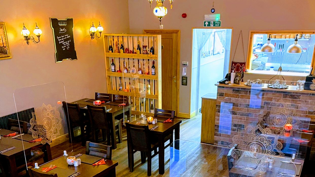 Inside Lezzet: warm lamps and wooden tables