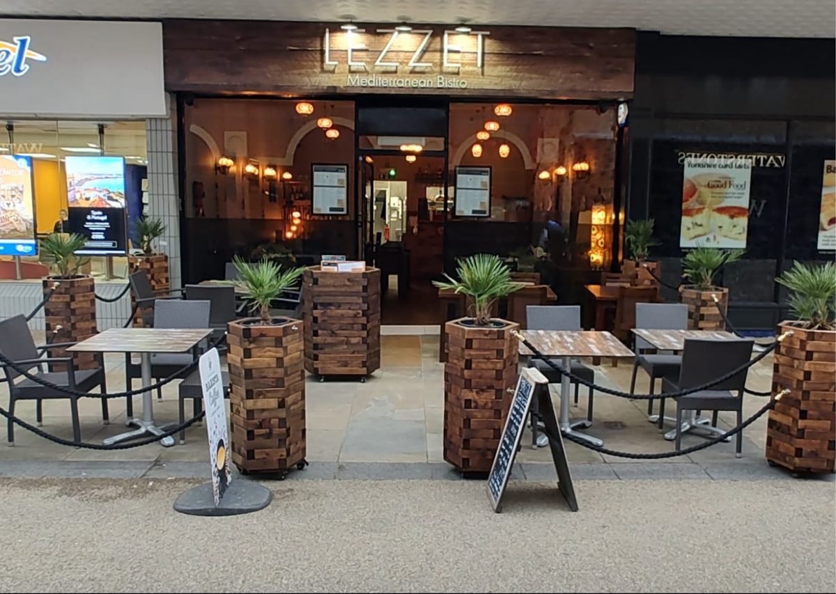 Lezzet frontage with its outdoor tables and planters on Aberdeen Walk